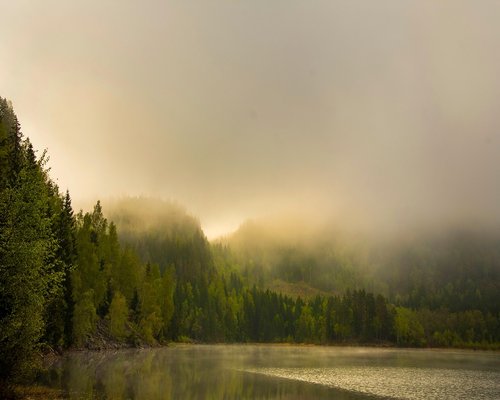 Calm woman meditating at sunrise with green Colombian mountains in background